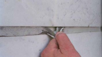 Adhesive failure, caulking tearing away.